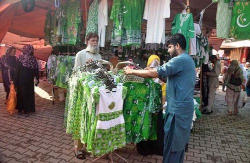 A vendor selling ladies dresses with national flags for patriotic citizens for upcoming Independence Day on 14th of August.