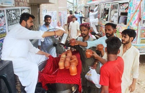 People getting water at a ”Sabeel” on the route of mourning procession Sialkot Punjab